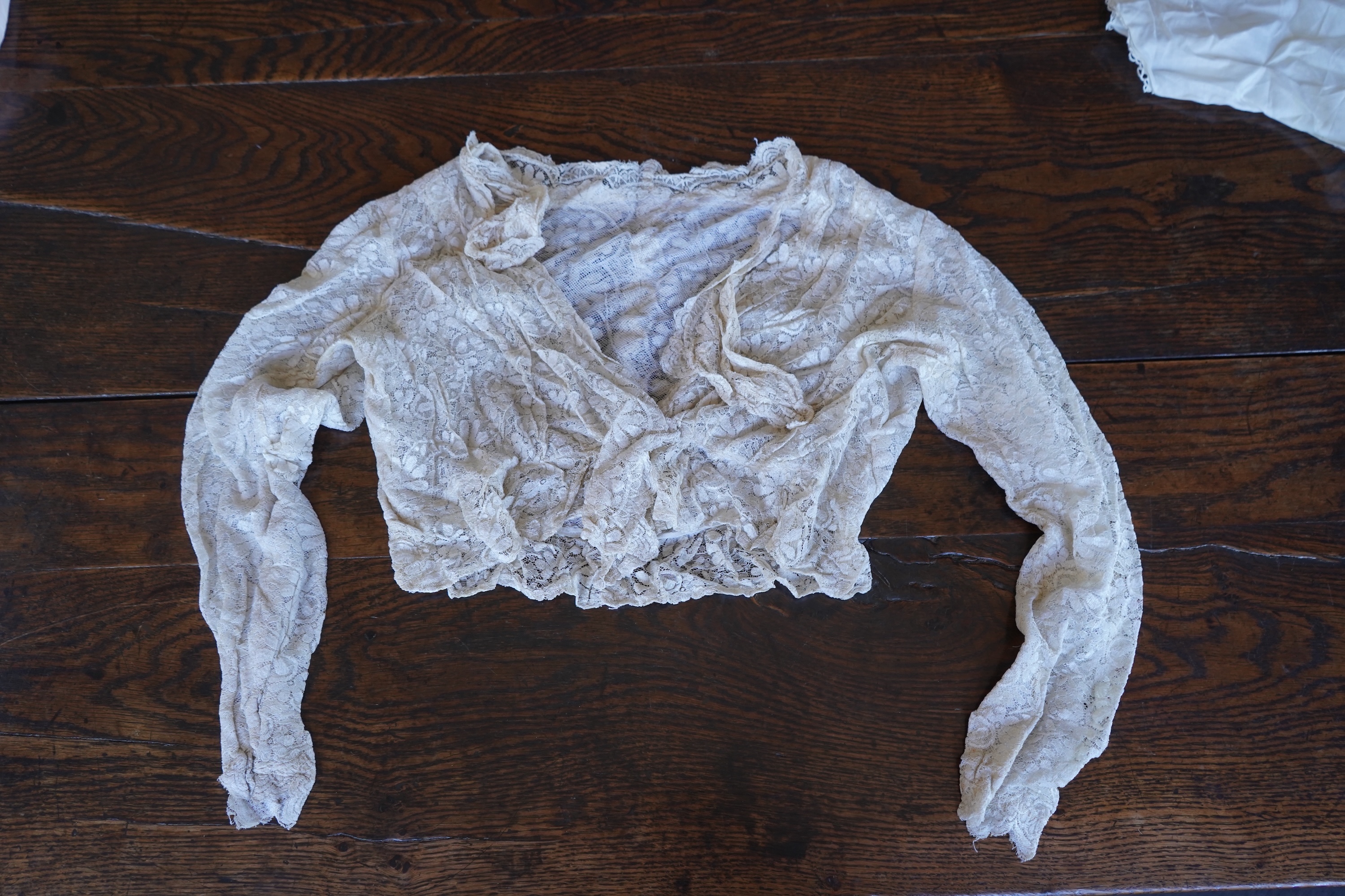A collection of 1920's-30's silk and satin camisole slips, two cream silk and lace jackets, a lace blouse a silk embroidered blouse, a silk cami, and a collection of silk stockings., Condition- good